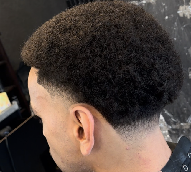 Precision afro fade with clean lines.