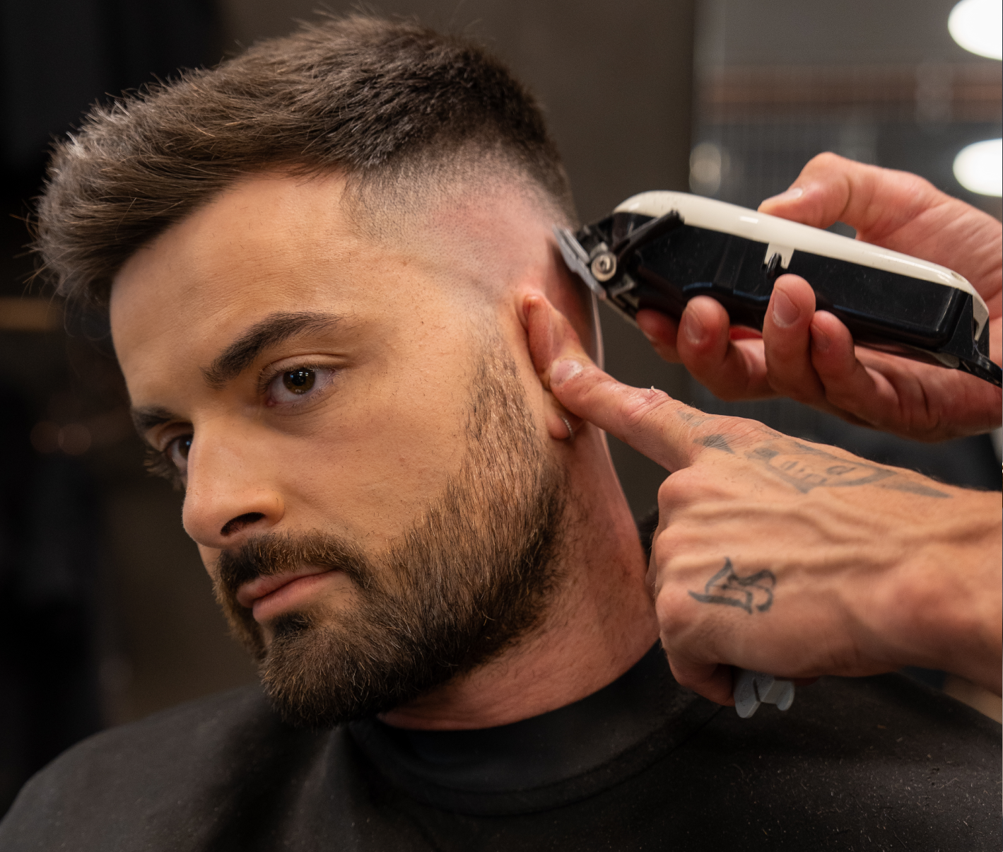 Barber styling a fresh cut.