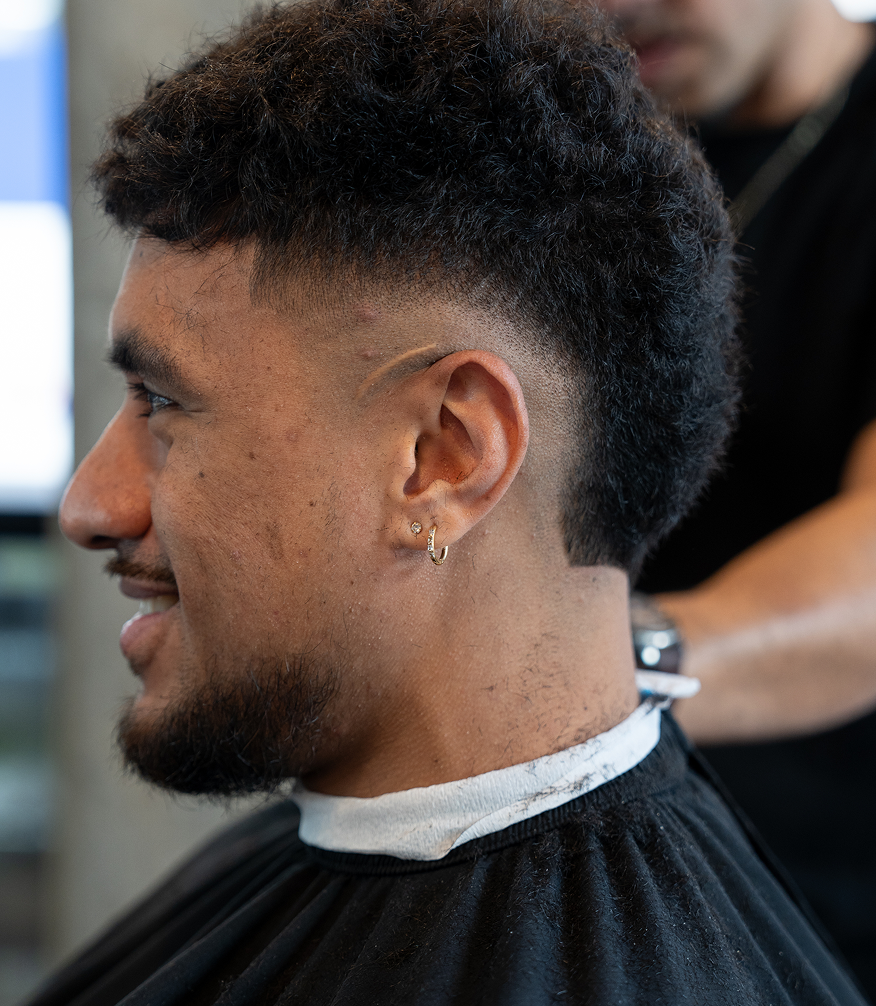 Barber and client mid-conversation.