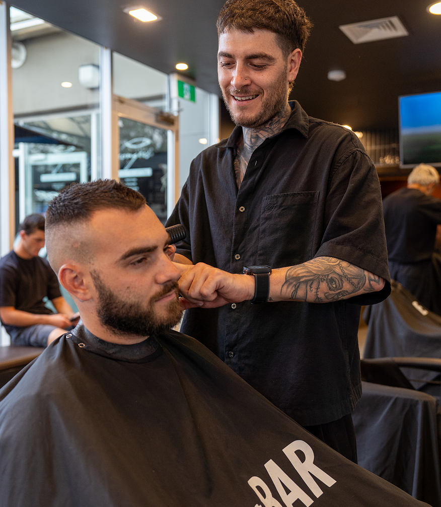 Bar x Bar barber working a fade.